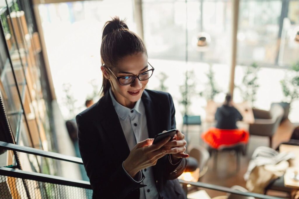 Woman on phone searching how to choose between Scorp or LLC from Simpson Financial Consulting